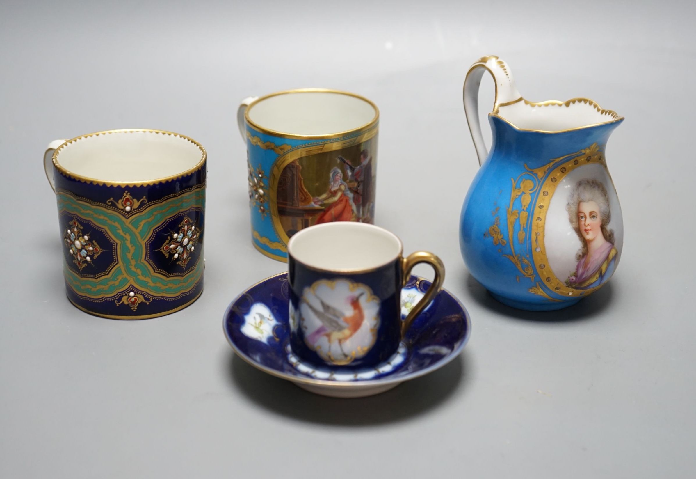 Two Sevres style porcelain coffee cans, cream jug and a cup and saucer, tallest ug 10 cms high.